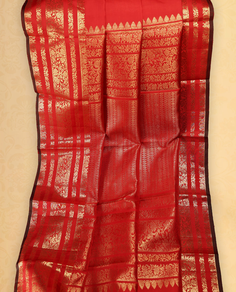 Deep red colour pure Kancheepuram saree with gold zari small floral motifs on the body, traditional border with floral kodi motifs and dark piping grand gold zari woven pallu, paired with contrast matching blouse