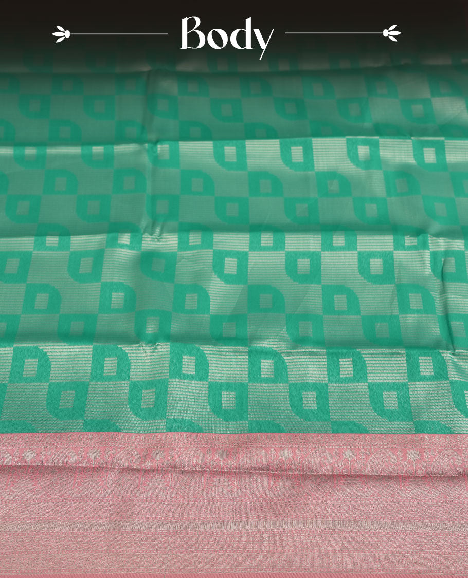 aqua green colour semi silk saree adorned with silver zari designs on the body, complemented by a contrasting pastel pink border and pallu, and paired with a matching blouse piece.
