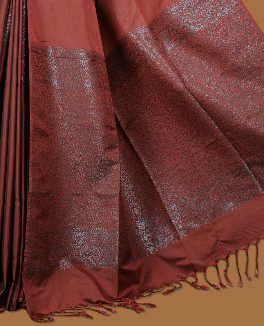 Deep red colour semi soft silk saree adorned with delicate woven floral kodi motifs on the body, complemented by a Self colour woven pallu with intricate detailing and tassel accents without border & Comes with a matching blouse piece.