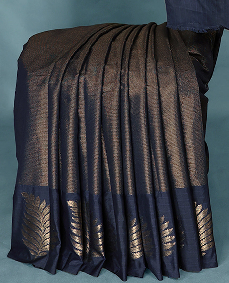 Navy Blue Colour Semi Tussar Silk saree featuring golden zari horizontal lines across the body, adorned with bold Leaf motifs on the border, paired with a matching blouse.