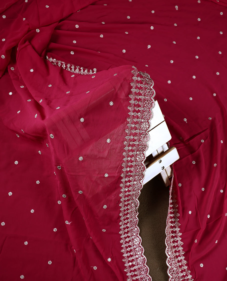 Pinkish red colour churidhar material beautifully designed with golden floral embroidery and multicolour thread highlights, paired with a plain matching bottom and an elegant embroidered dupatta.