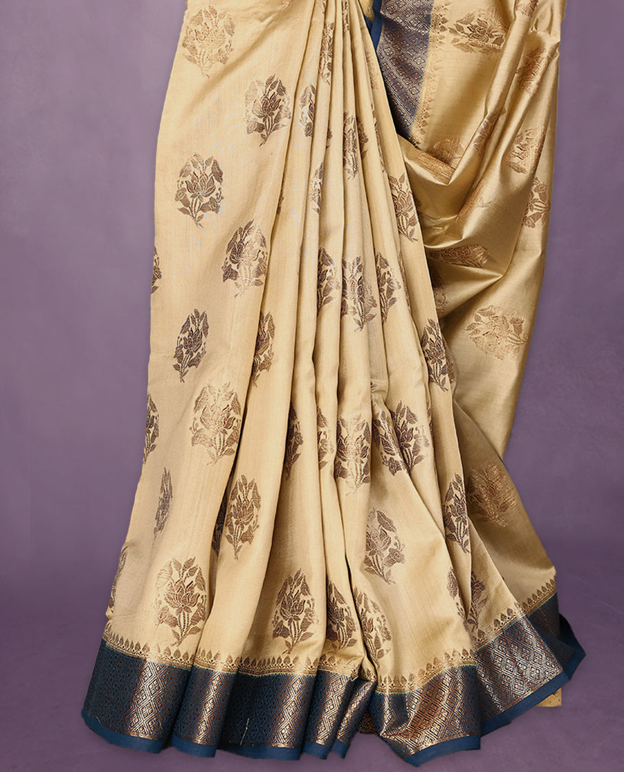 Beige Colour Pure Banaras Soft Silk Saree adorned with traditional antique zari motifs, paired with a hand dyed German Blue antique style border and a matching blouse.