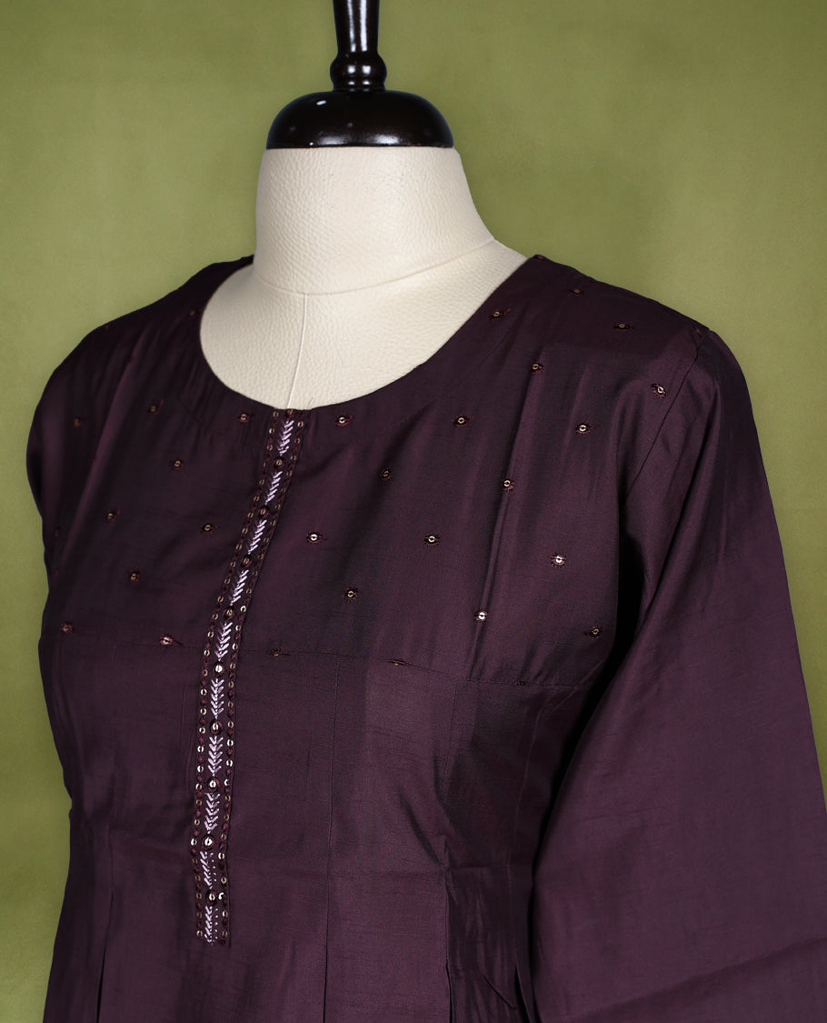 Rich Brown coloured kurti crafted in silk blend fabric, adorned with subtle beadwork on the yoke and embroidered placket, featuring a round neckline and 3/4th sleeves with embroidered cuffs.