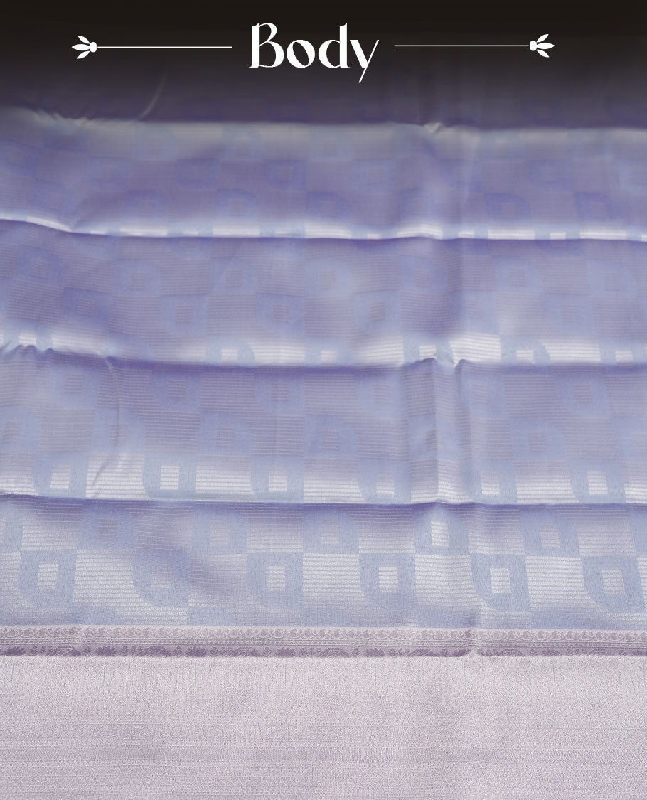 Light lavender colour semi silk saree adorned with subtle silver zari motifs on the body, complemented by a pastel light blue pallu intricately woven with rich floral patterns border and pallu, and paired with a matching blouse