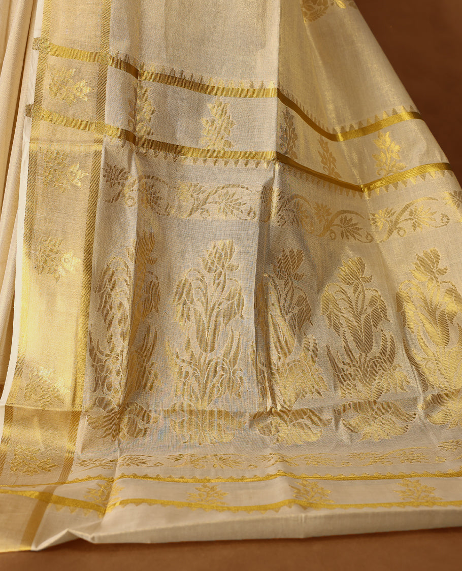 Elegant Light Gold colour Tissue Kerala saree featuring Gold Zari Motifs on body, traditional golden zari kasavu border with Floral Motifs & Rich Pallu offering a classic and graceful look, paired with a matching blouse.