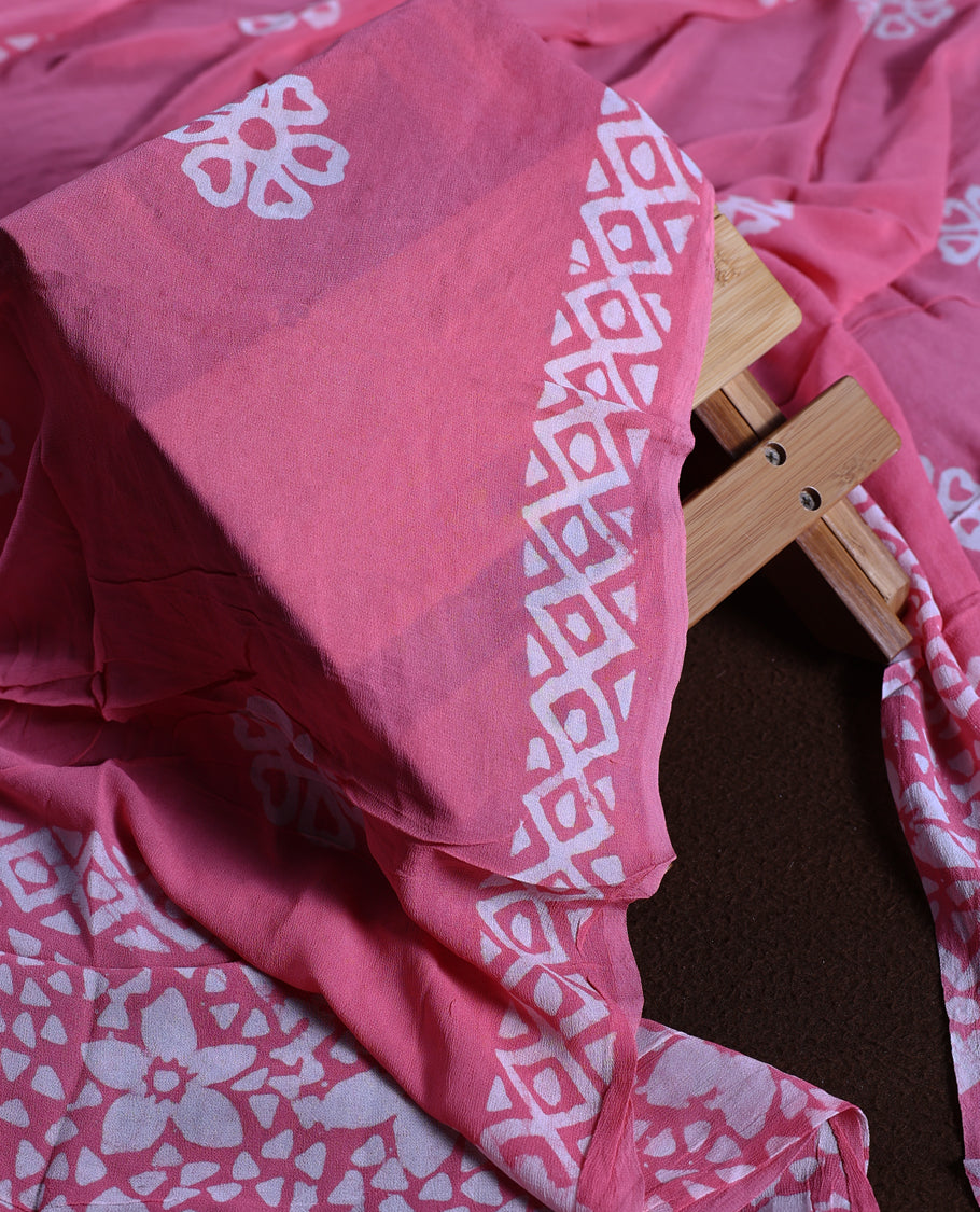 Pink colour churidhar material adorned with gold and copper toned floral patterns and bold block designs, paired with a plain matching bottom & Comes with a floral flowery printed dupatta.