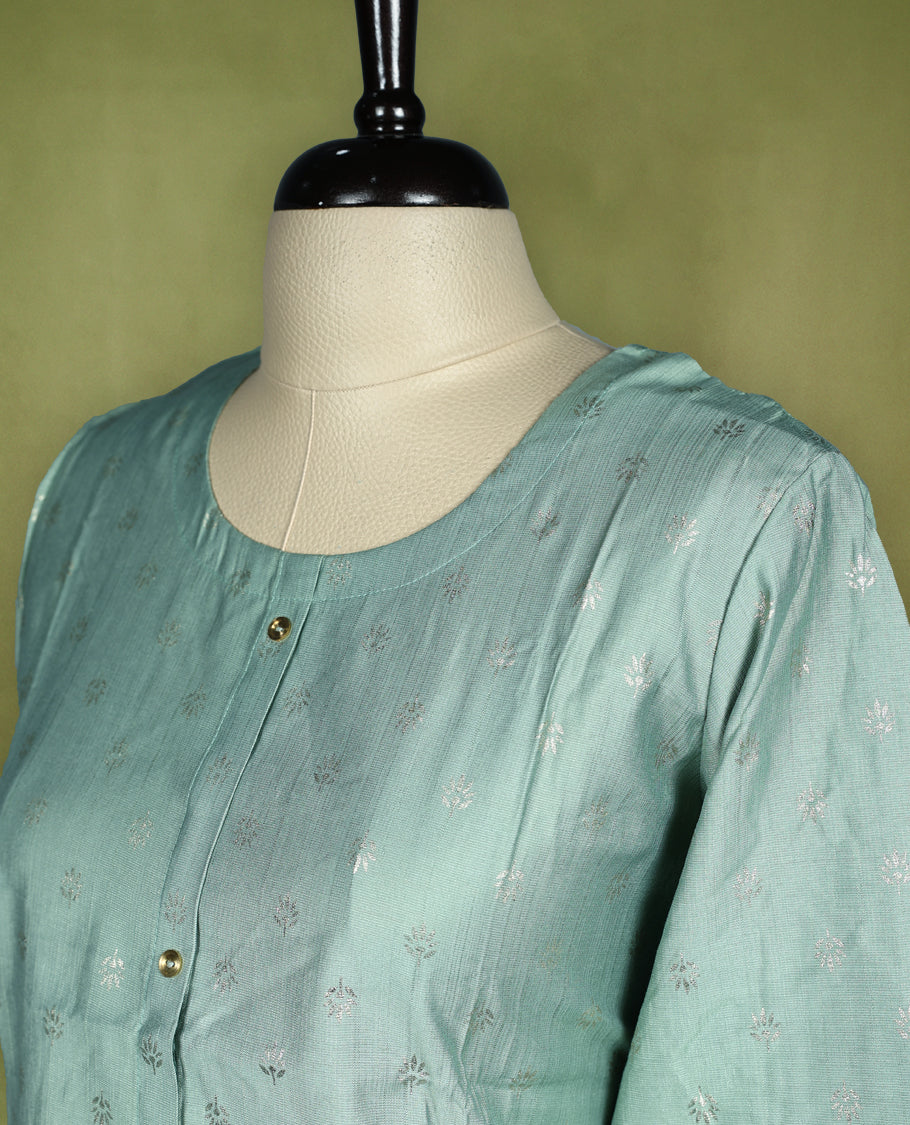 Pista green colour straightcut kurti crafted in soft fabric featuring subtle butta work all over, designed with a round neckline, front button placket and 3/4th sleeves.