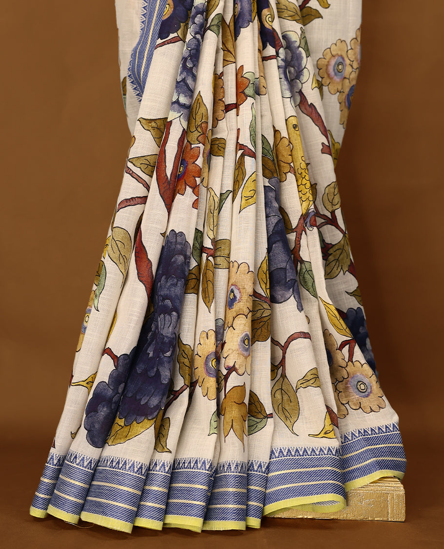 Off-white Colour lightweight khadi cotton saree featuring earthy-coloured digital floral kodi prints on the body and pallu, accented with a Blue border paired with a matching blouse.