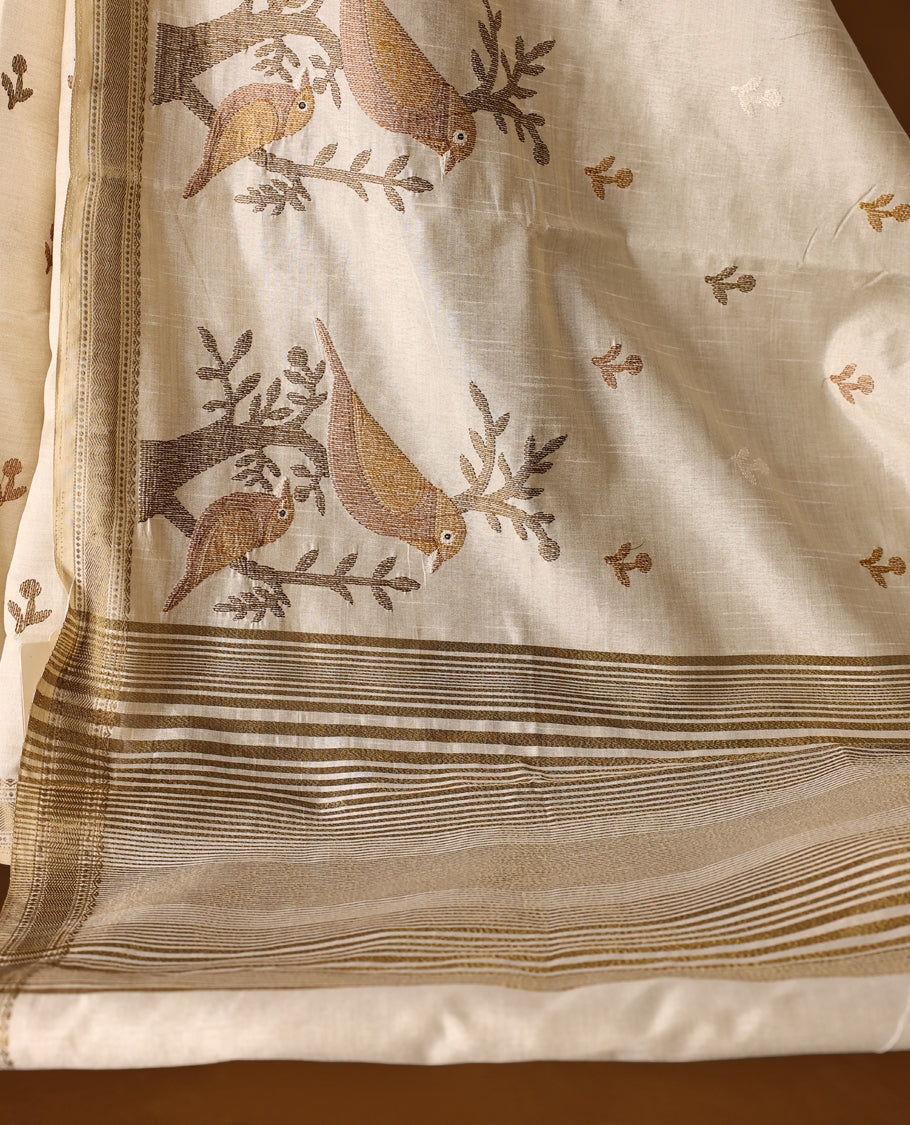 Soft Tussar saree in elegant off white shade, featuring intricate bird and branch motifs across the body, enhanced with a subtle grey golden woven border and pallu, paired with a matching blouse.