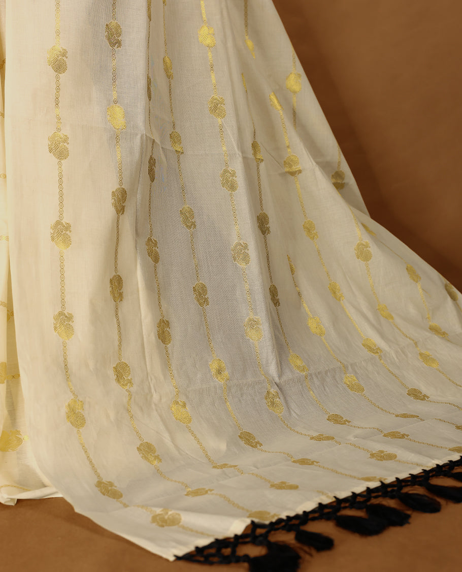 Light Gold colour Tissue Kerala saree featuring Gold zari Stripes with Peacock motifs on body, with Black colour tassels with a matching blouse perfect for festive occasions.