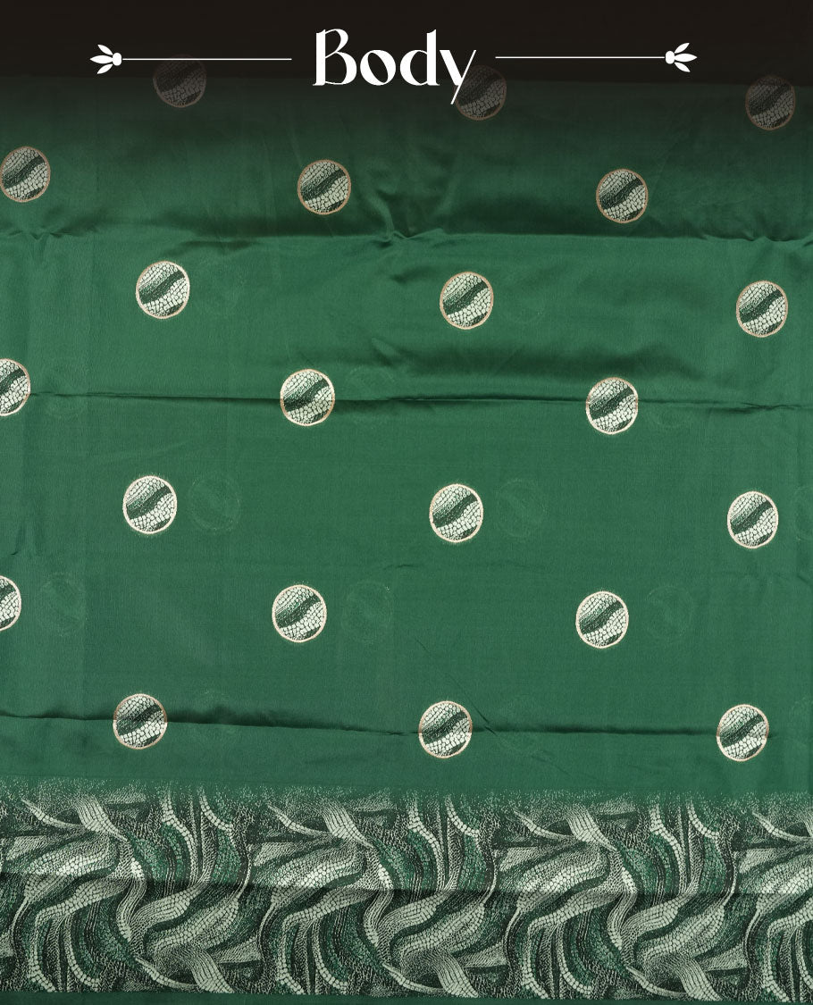 Dark green semi silk saree featuring elegant circular motifs on the body, complemented by a striking pallu adorned with intricate wavy silver thread patterns, and paired with a matching blouse