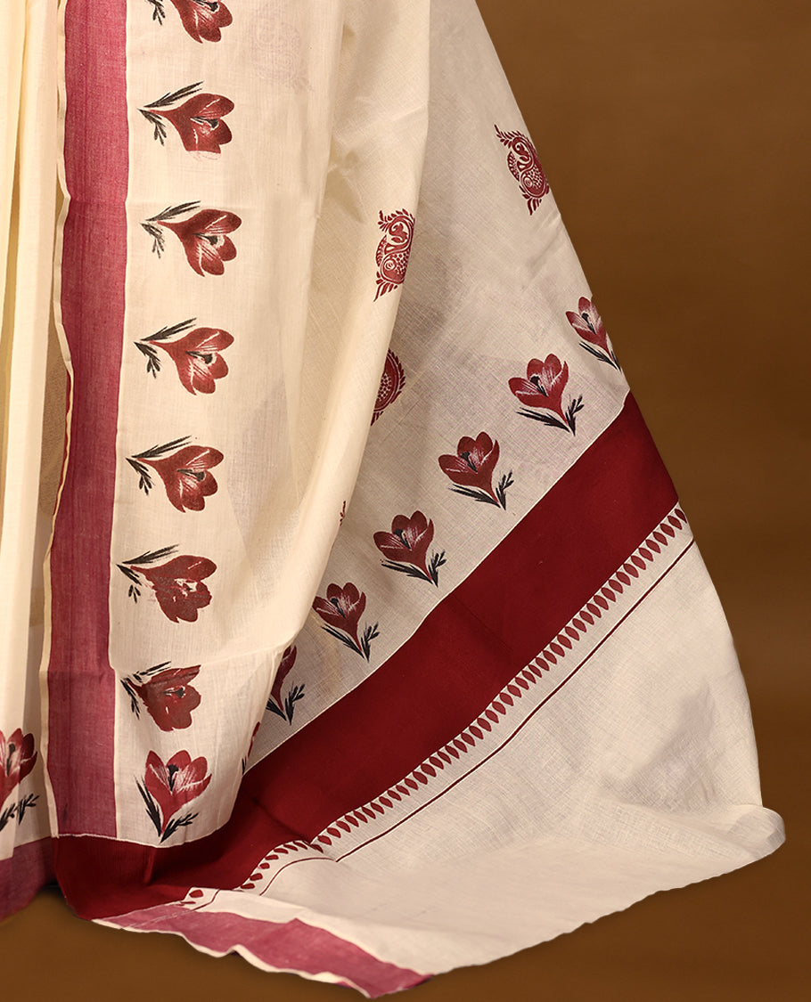 Kerala cotton saree showcases charming red floral Prints complemented by a deep maroon border with Matching Blouse