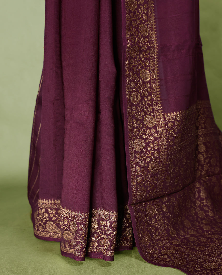 Maroon colour Tussar Banaras saree featuring a plain body, rich floral woven zari border and grand pallu, paired with a matching blouse for an elegant and regal traditional look.