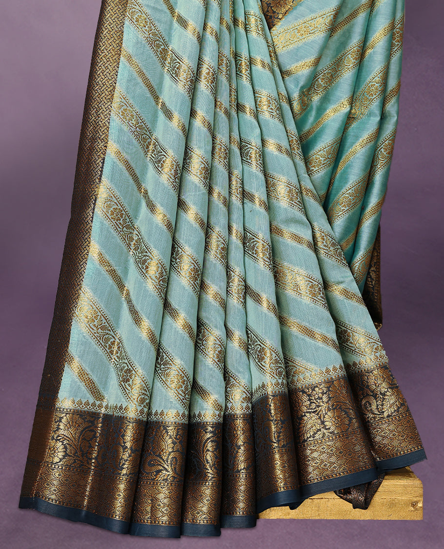 Sky Blue colour pure Banarasi Chanderi cotton, exquisitely detailed with traditional antique zari Aada designs across the body, finished with a hand-dyed contrast traditional border and a matching blouse.