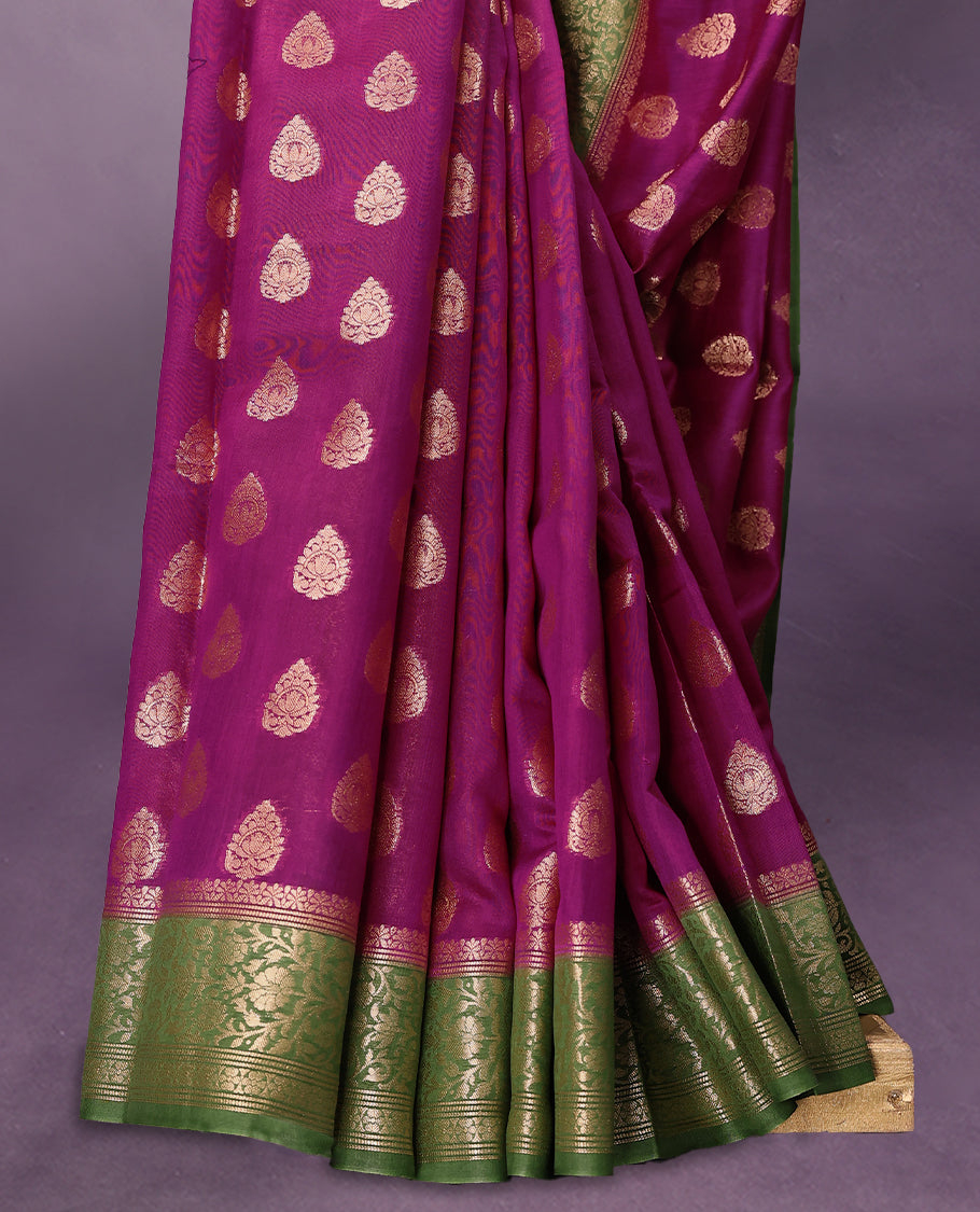 Rani colour pure Banarasi Chanderi cotton fabric, featuring traditional antique zari buttas on the body, complemented by a traditional Green Colour border and a matching blouse.