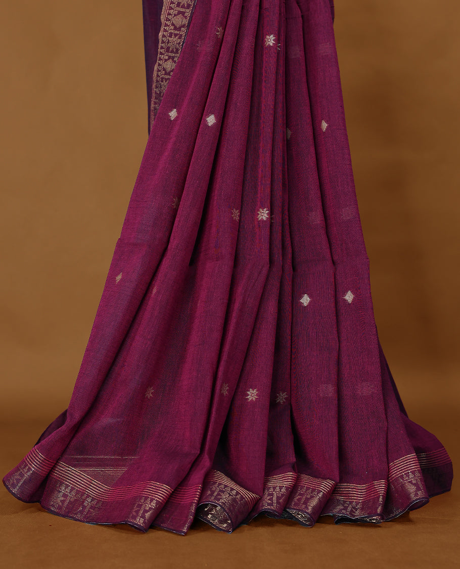 Deep Magenta colour soft khadi cotton saree with small Beige Zari Flower motifs on the body, detailed woven Gold zari border, paired pallu with tussles, with matching blouse.