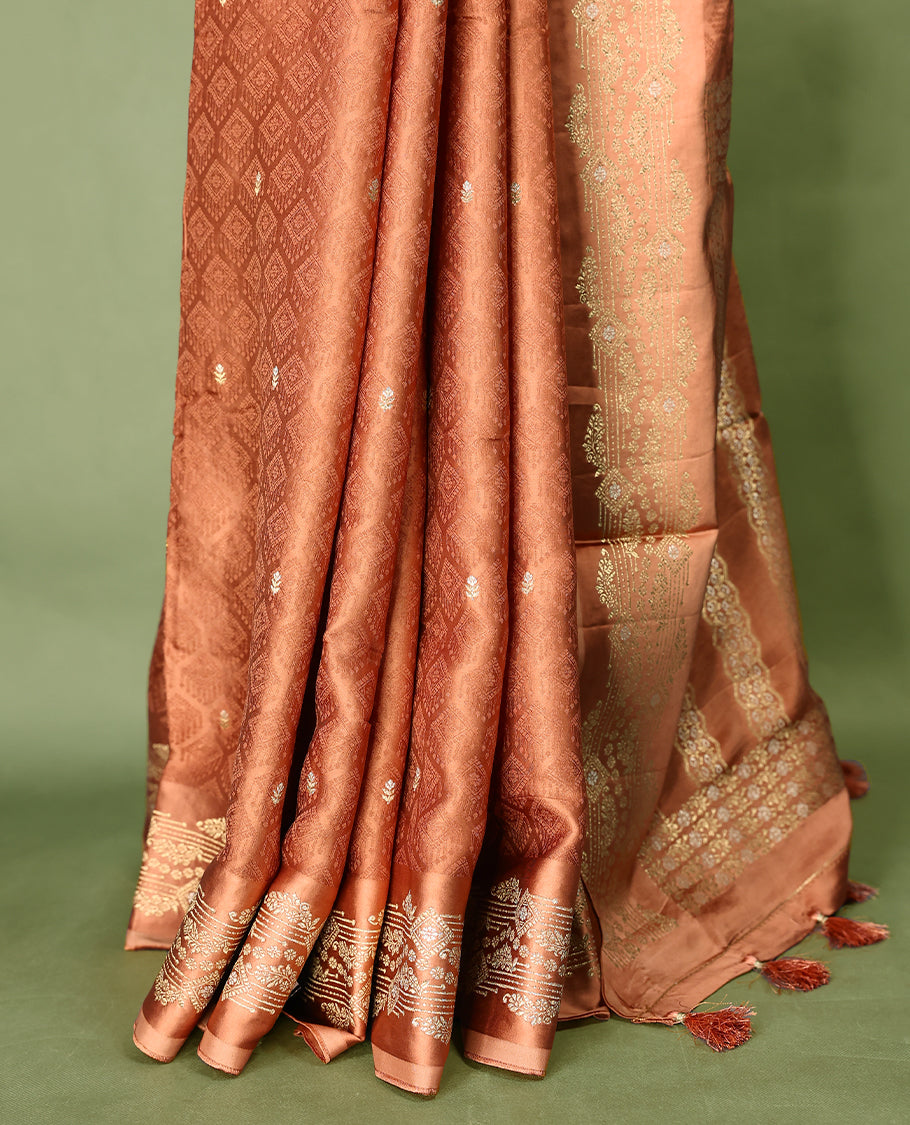 Pastel Brown colour pure Banaras crepe saree showcases elegant Gold & Silver zari Motifs all over the body, a traditional gold & Silver zari border, a rich intricately woven pallu, and comes with a matching blouse.