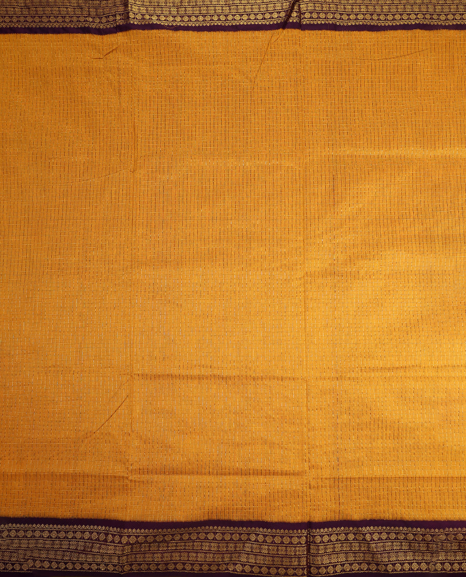 Bright Mustard colour mixed Kalyani cotton saree featuring Gold zari checks throughout the body, paired with Deep Grape colour traditional border and pallu, with matching blouse