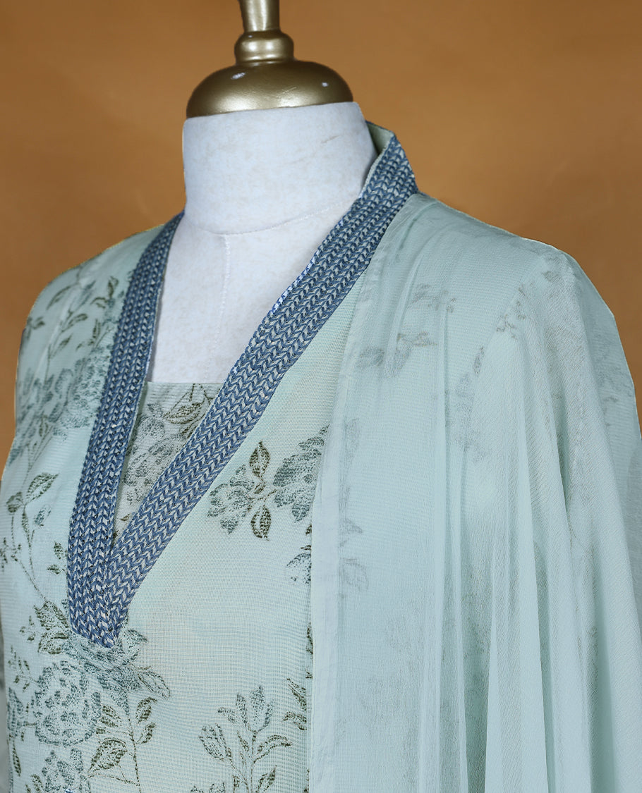 Baby blue colour salwar from TWARA, featuring a V-neck adorned with sequins and thread work, with floral prints on the top, paired with a matching bottom and dupatta.