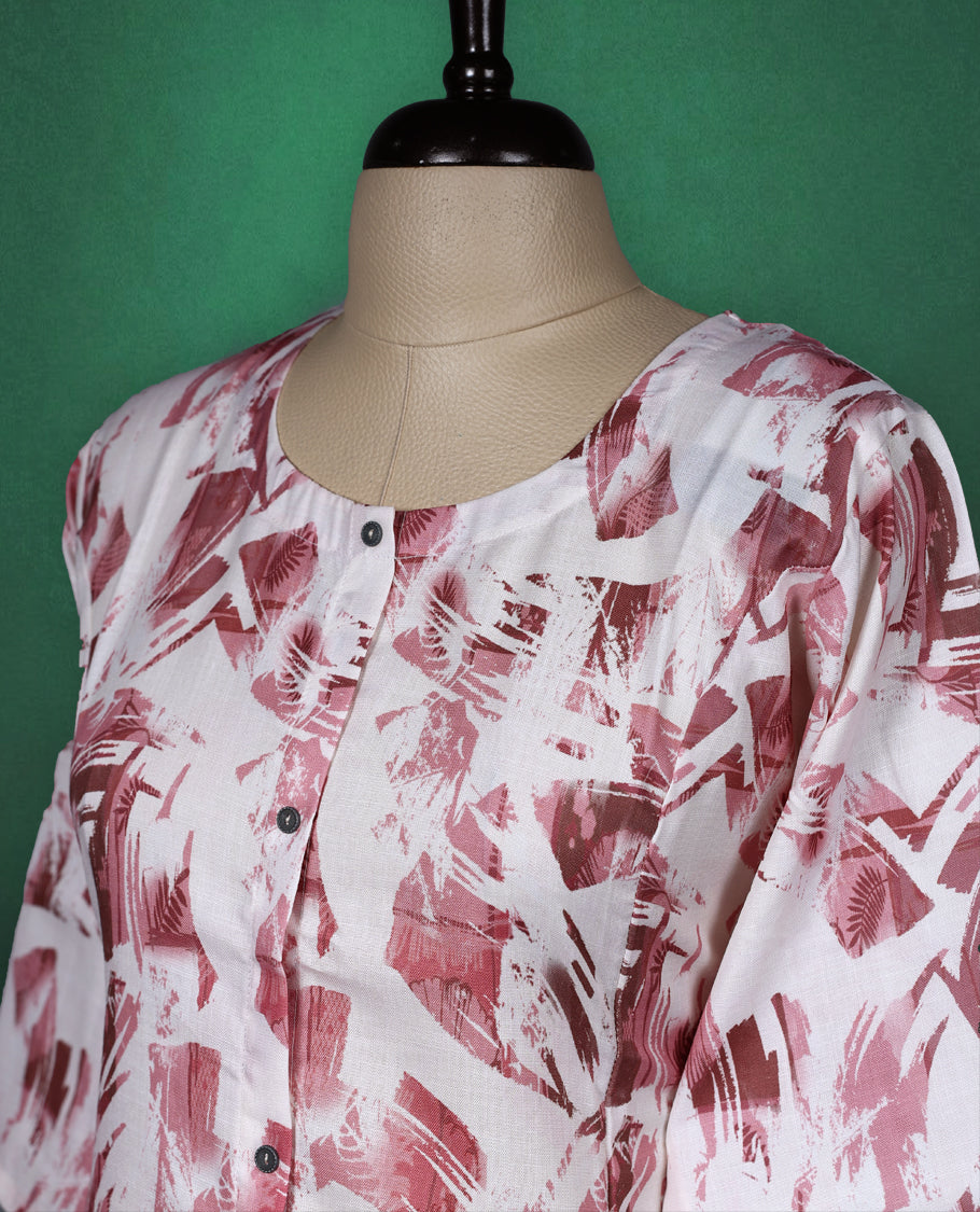 White cotton kurti with abstract Pastel maroon brushstroke prints, featuring a round neckline, front button detailing, and elbow length sleeves a stylish choice for casual daywear.