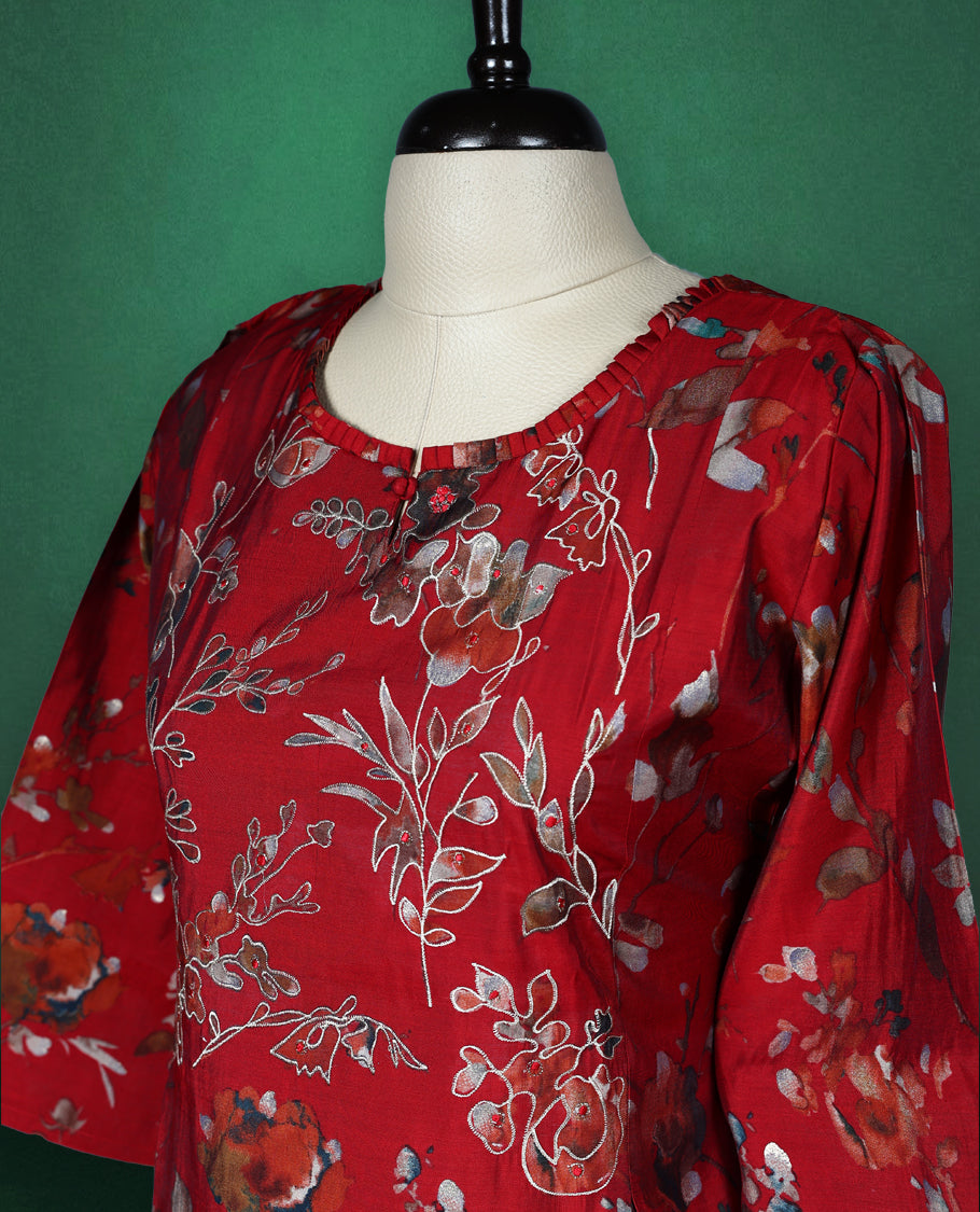 Elegant red kurti with all over floral print, styled with a round neckline, elbow length sleeves, and a straight cut silhouette perfect for casual or semi formal wear.
