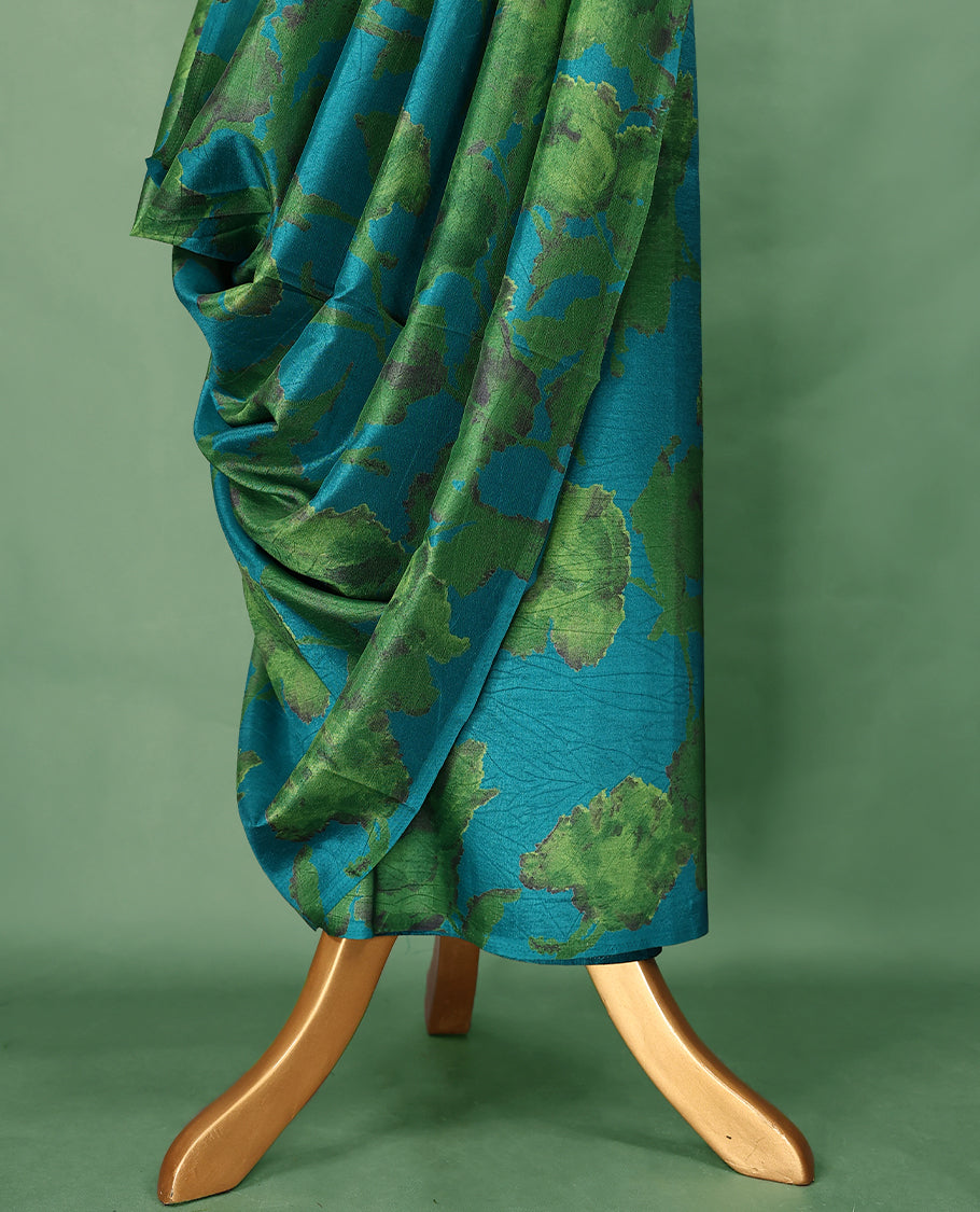 Teal blue colour Manipuri saree features a body with abstract leafy patterns in shades of green, without border, and comes with a matching blouse.