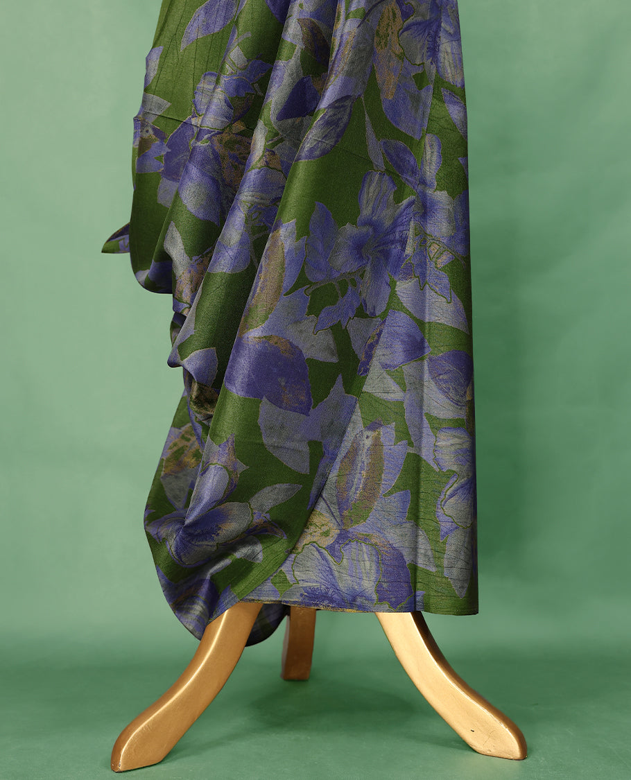 Deep olive green Colour Manipuri saree featuring oversized periwinkle blue and muted floral motifs, finished without a border, and paired with a matching blouse.