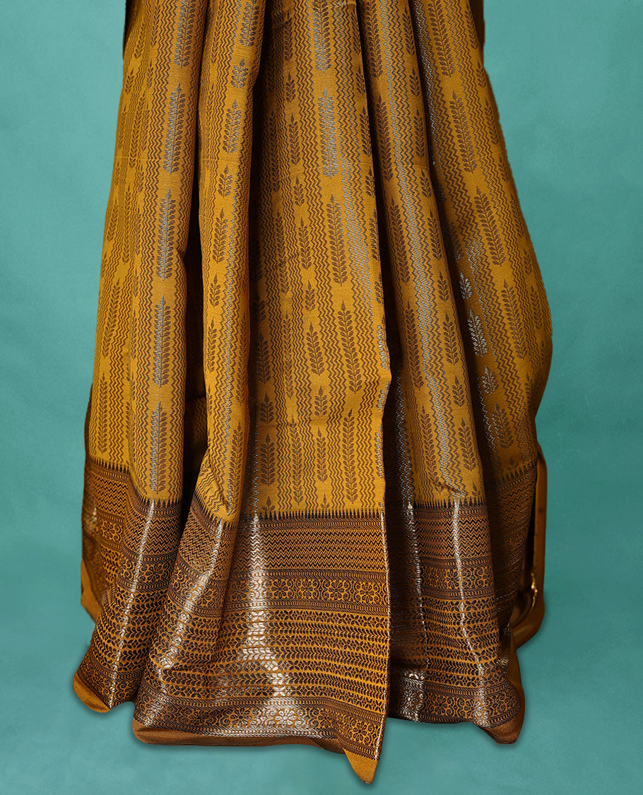 Mustard Art Soft Silk Saree showcases intricate silver zari work on the body and border, paired with a matching blouse