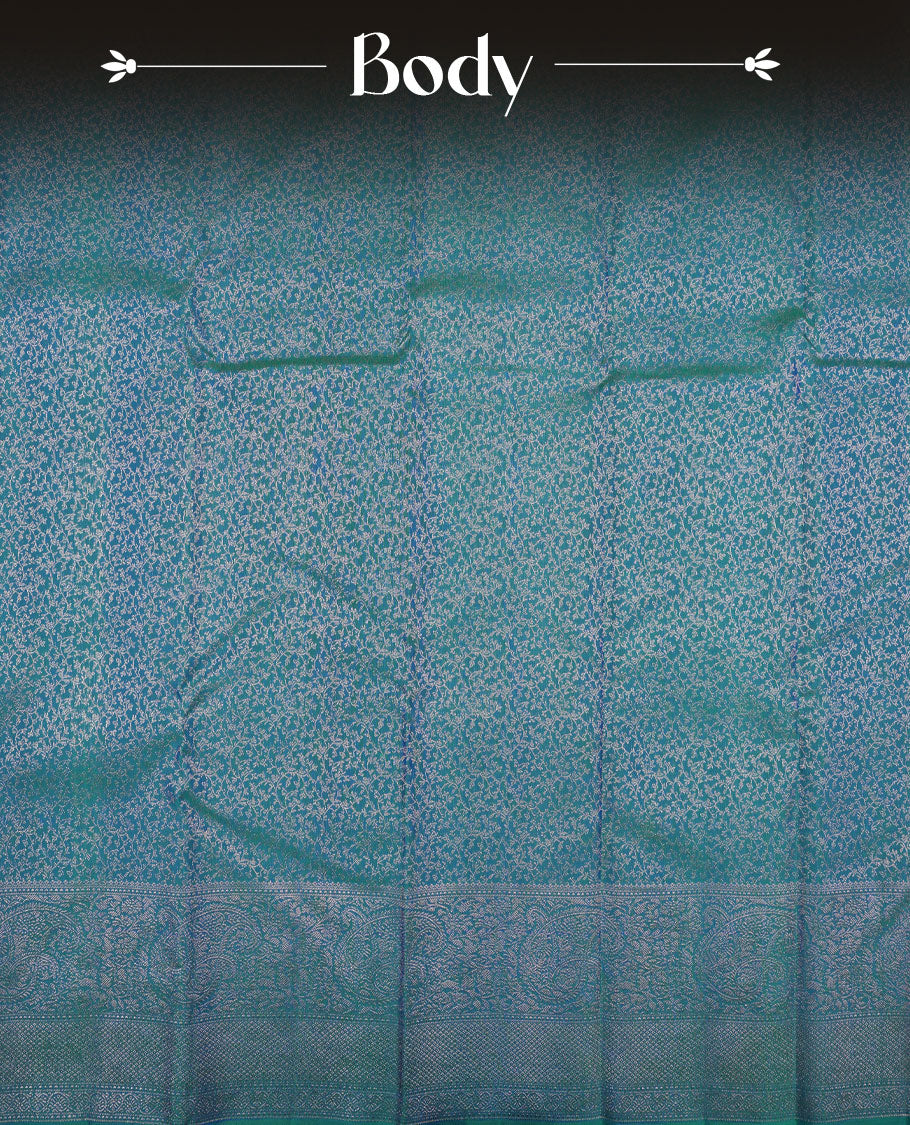 Peacock blue colour Kanchipuram pattern Manthrakodi saree featuring geometrical design antique copper zari floral pencil art jacquard design across the body, traditional mango & diamond designs on border, and self zari blouse piece.