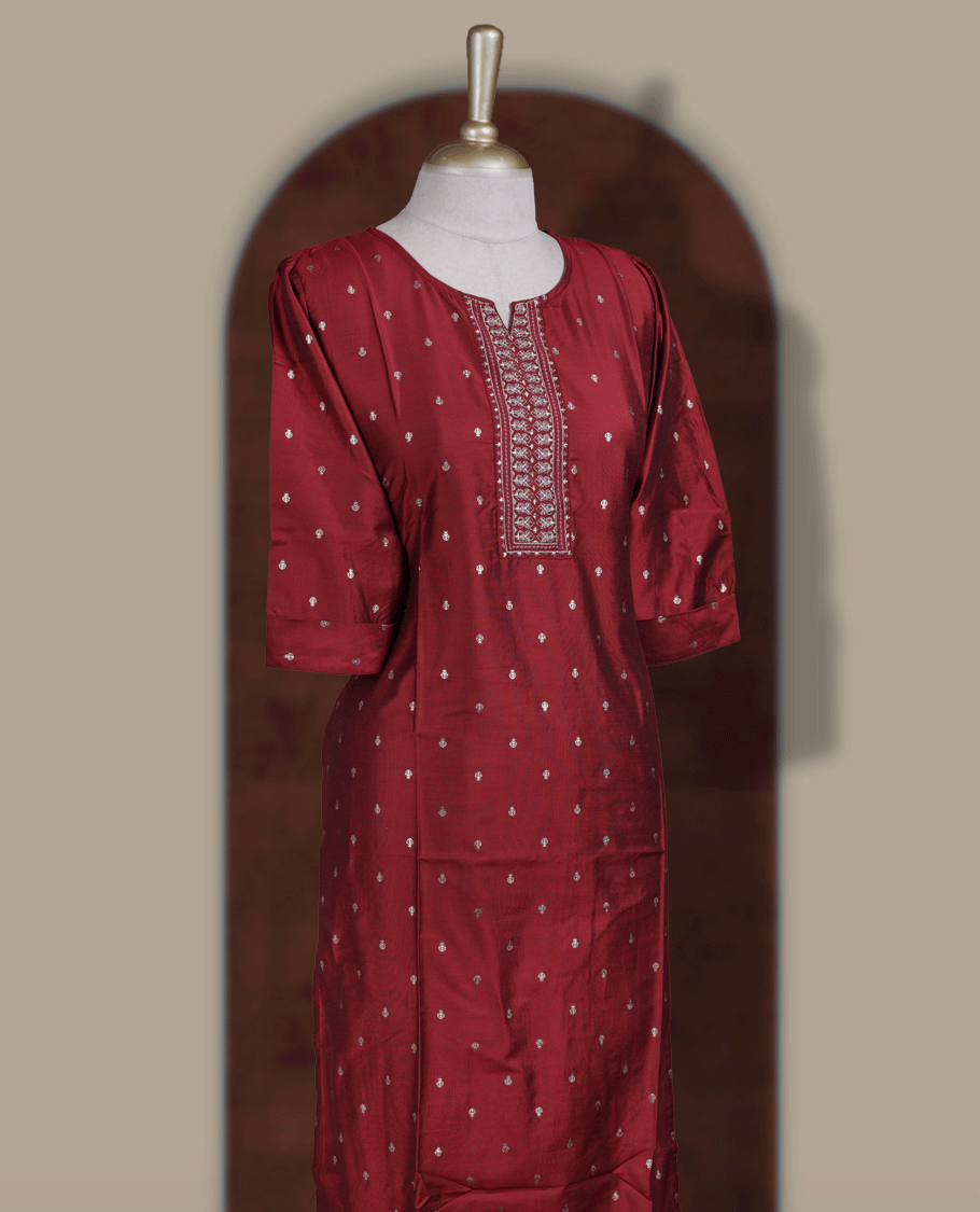 Deep maroon colour kurti from TWARA, adorned with subtle elegant motifs and intricate embroidery on the neckline, finished with a round neck and elbow length sleeves.