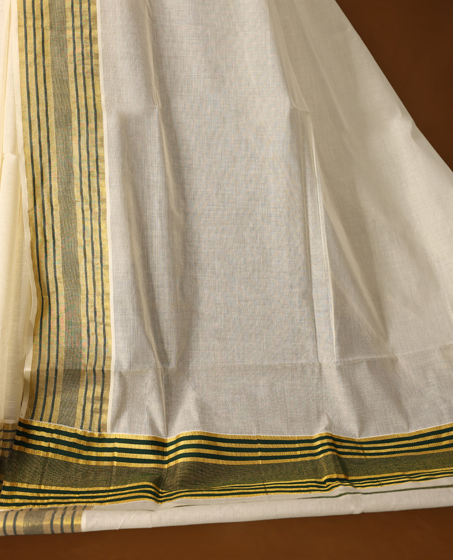 Elegant off white colour cotton Kerala saree with a soft cream body, adorned with traditional golden zari work,It features a green and gold striped border, offering a perfect blend of simplicity and festive charm & Includes blouse piece.