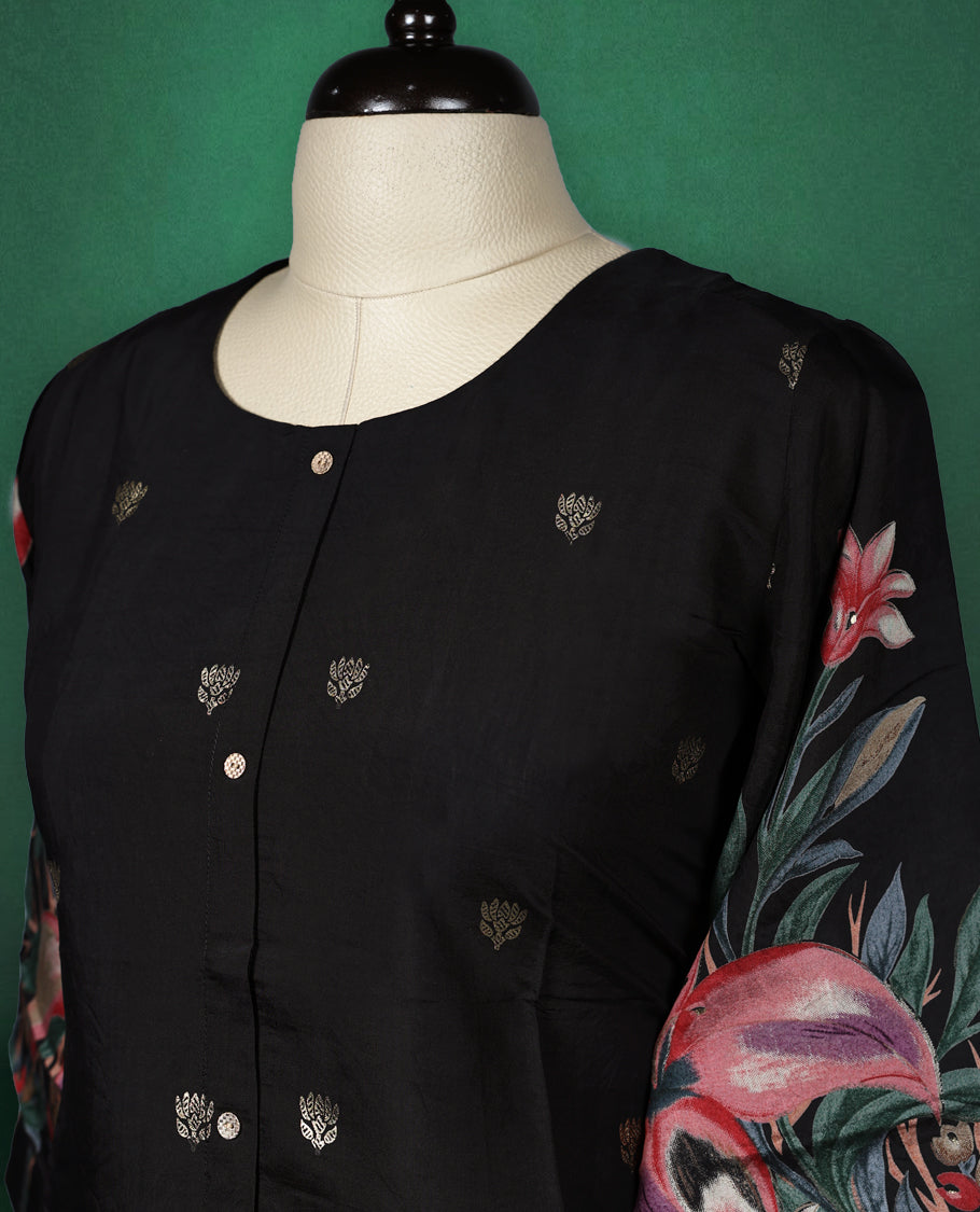 Black colour short kurti featuring a round neck and three quarter sleeves, adorned with soft golden motifs and a vibrant floral print along the hem and sleeves for a bold, elegant finish.