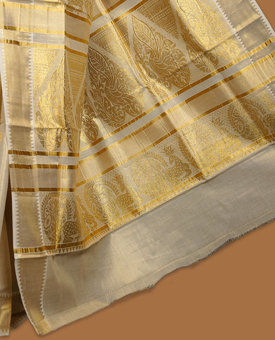 Elegant light gold tissue Kerala saree featuring delicate tree-inspired gold zari buttas across the body. Finished with a broad traditional kasavu border and a richly woven pallu, paired with a matching blouse