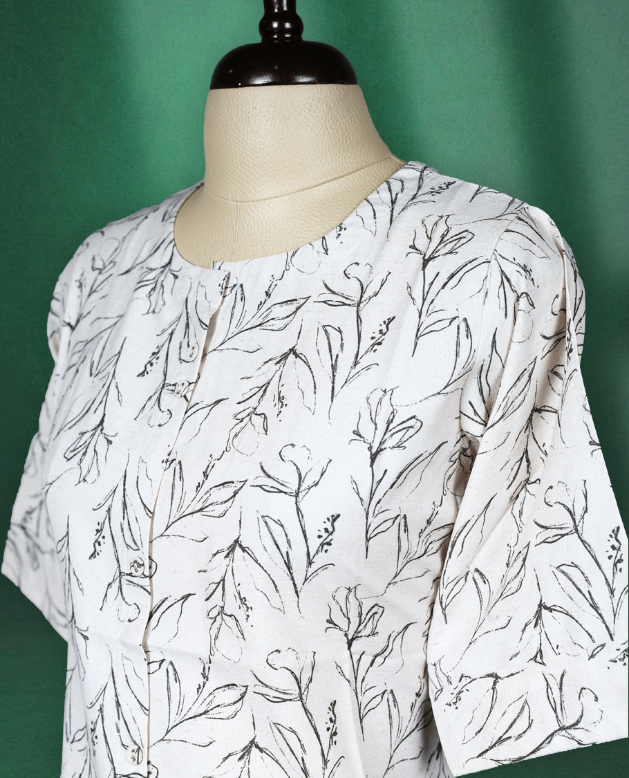 White short kurti featuring a soft cotton base with elegant all over black leaf print, styled with a round neckline and elbow length sleeves for a casual and breezy everyday look