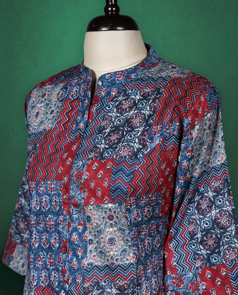 Multicolour colour kurti adorned with vibrant patchwork style prints in shades of red, blue, and white, featuring a mandarin collar, front placket, and three quarter sleeves a bold and comfortable choice for everyday fashion.
