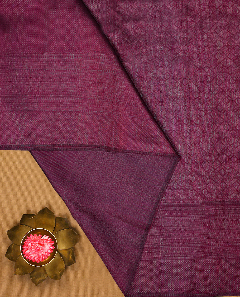 Cranberry coloured Manthrakodi saree featuring a multicoloured zari jacquard body, complemented by a self coloured turning Banarasi border and a matching self coloured blouse.