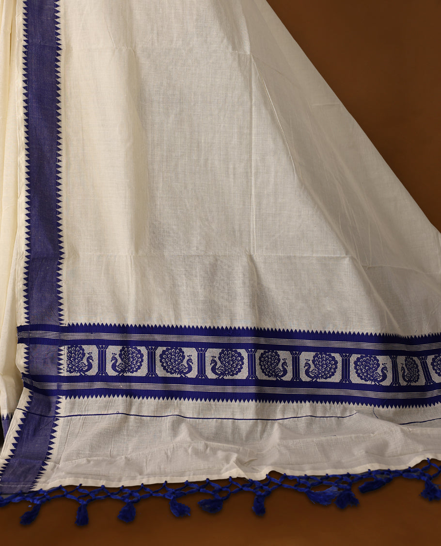 Elegant off white colour cotton Kerala saree featuring Plain body, Blue colour border with Peacock Motifs, Paired with matching blouse offering a classic and graceful look, paired with a matching blouse.