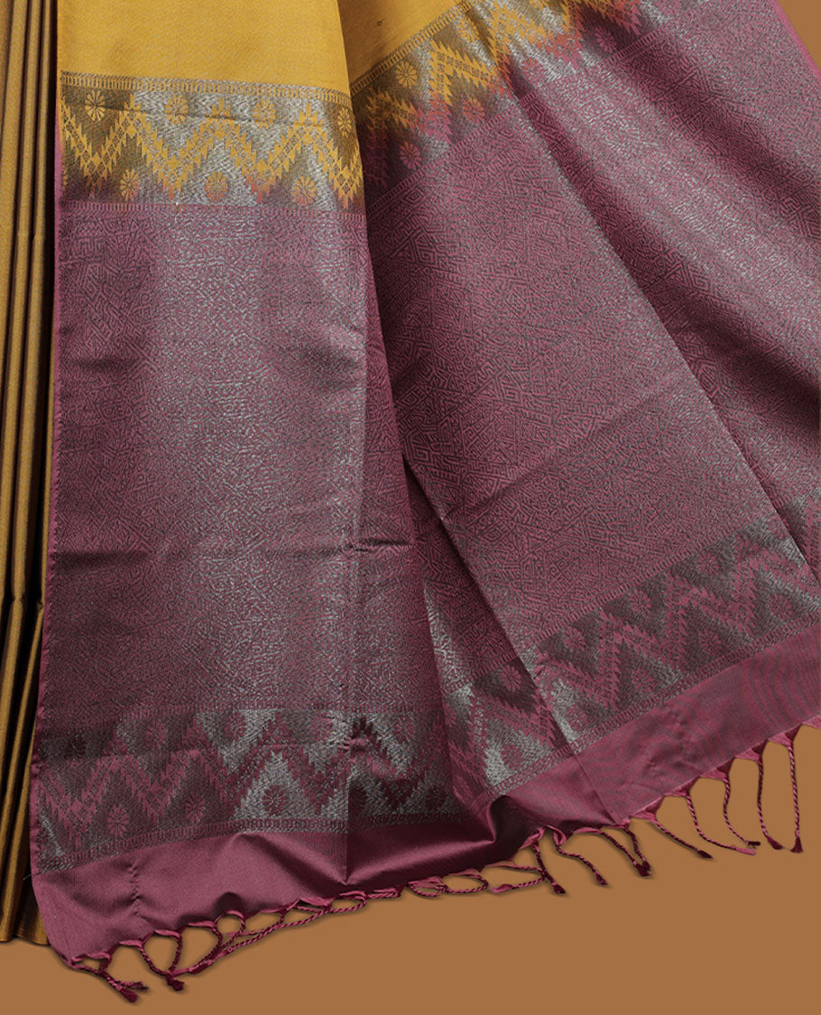 Dark mustard colour semi soft silk saree adorned with delicate woven motifs on the body, complemented by a Contrast rouge colour woven pallu with intricate detailing and tassel accents without border & Comes with a matching blouse piece.