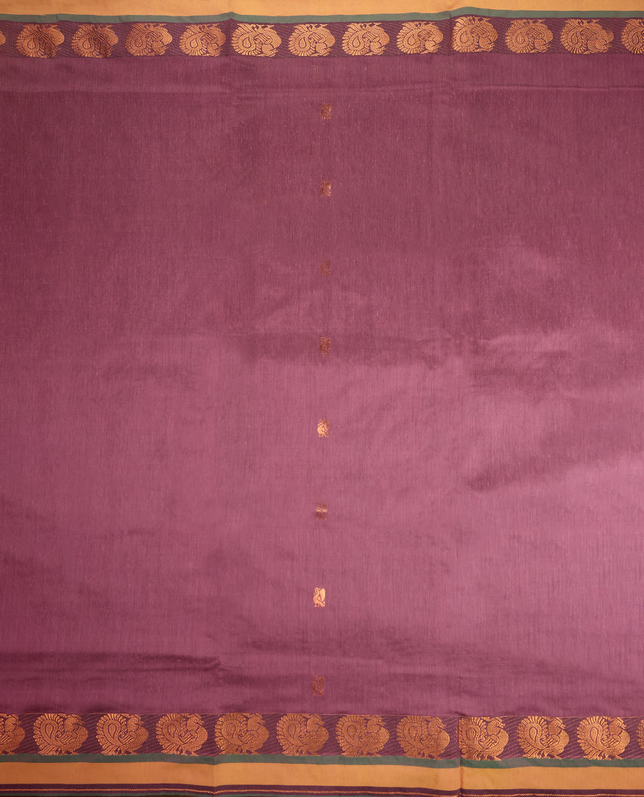 Lavender pink and Dark Green Kalyani cotton saree featuring intricately woven golden peacock and paisley motifs across the border and pallu, highlighted with a zari finish, and paired with a matching blouse.