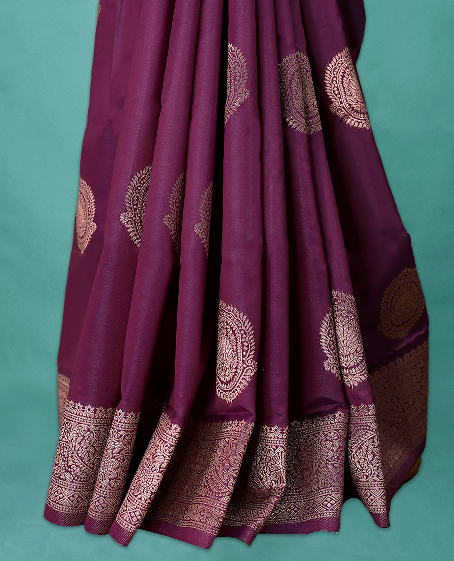 Grape Wine coloured semi silk saree featuring a Golden Zari Butta design on the body, paired with a Self coloured border and matching blouse.