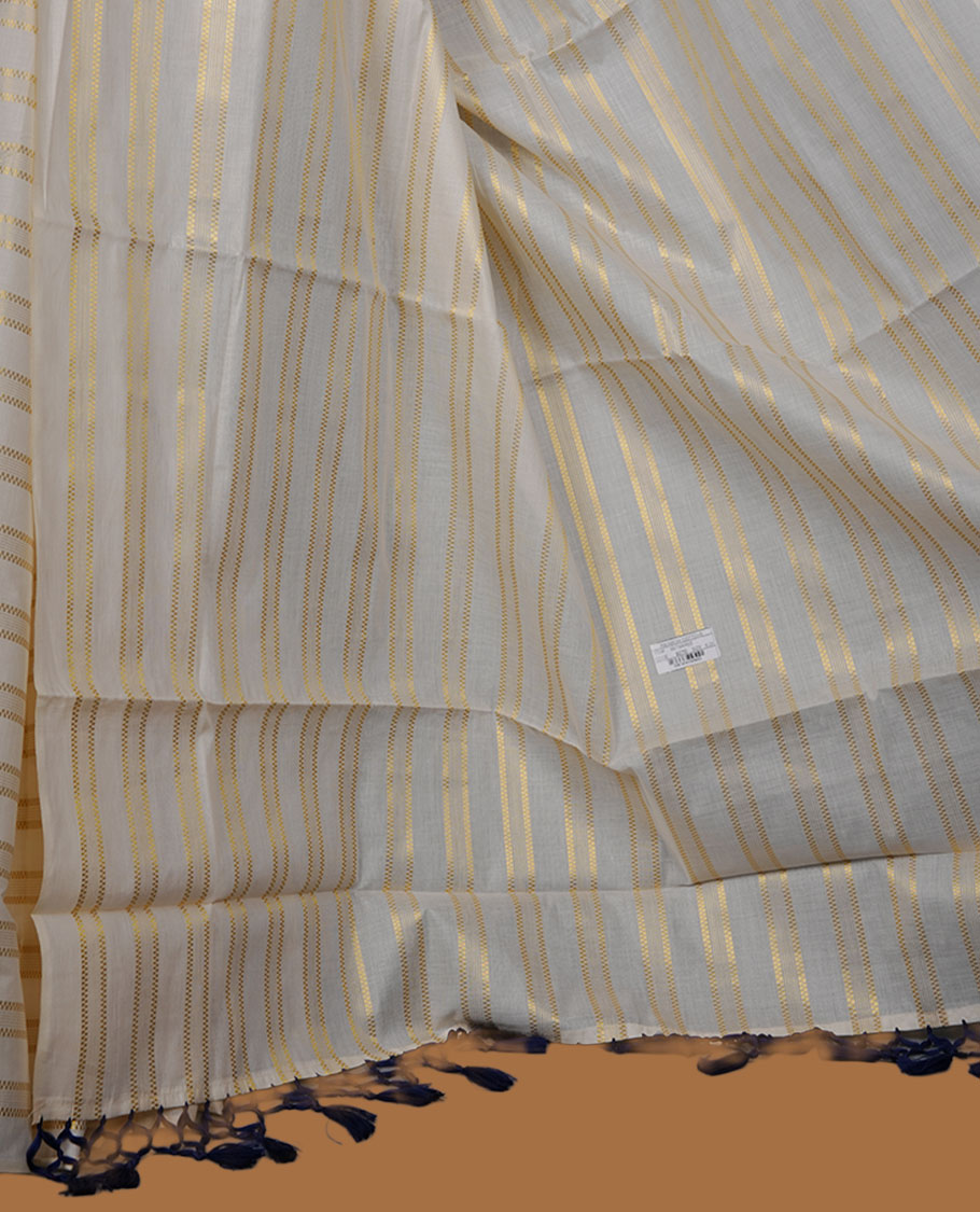 Off-white colour cotton Kerala saree featuring subtle gold zari stripe detailing across the body, finished with elegant tassels on the pallu, and paired with a matching blouse.