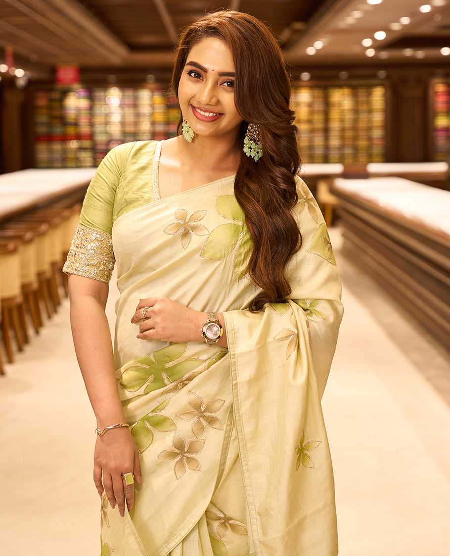 Light pastel green colour pure tussar silk saree featuring elegant hand painted floral designs, beautifully highlighted with subtle gotta work, paired with a matching blouse.