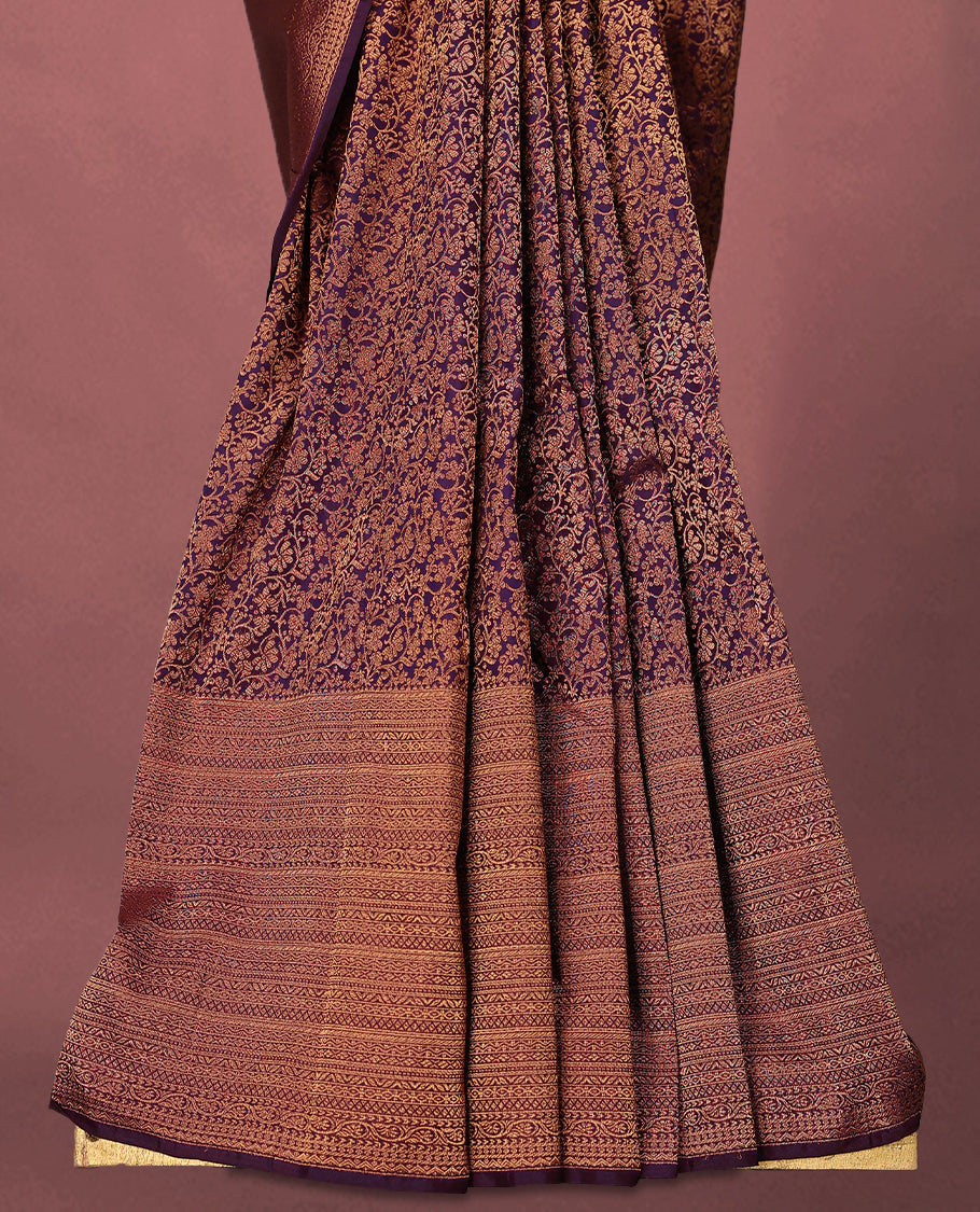 Royal Purple colour Kancheepuram saree featuring an antique zari brocade body, complemented by a traditional border and a matching blouse.
