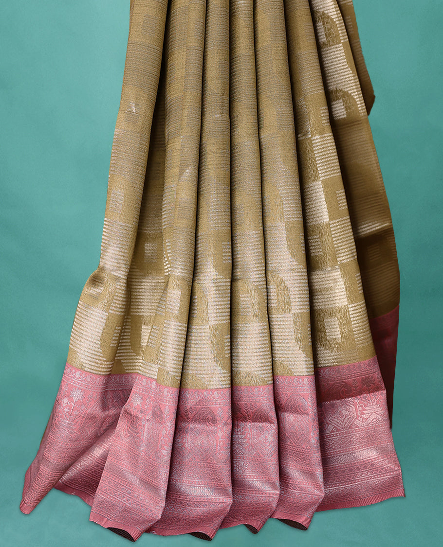 Dark Olive coloured semi silk saree featuring a Silver coloured Zari design on the body, paired with a Onion coloured border and blouse.