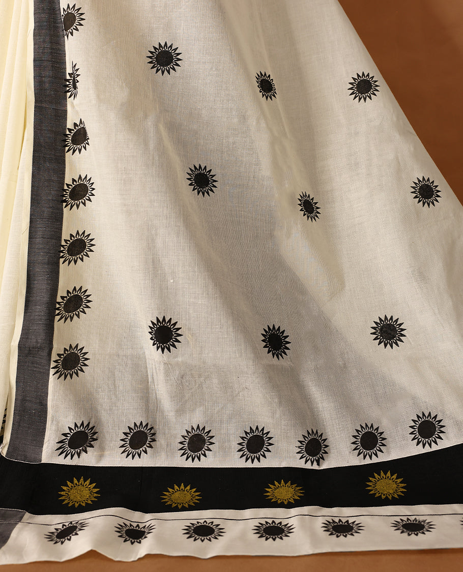 Elegant off white colour cotton Kerala saree featuring Plain body, Black colour border with Flower Block prints, Paired with matching blouse offering a classic and graceful look, paired with a matching blouse.