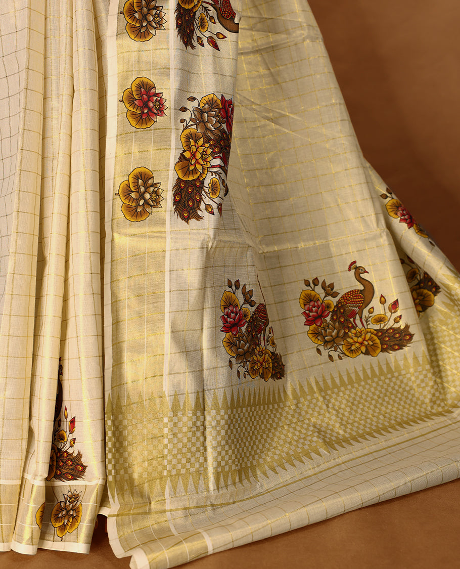 Light Gold colour Tissue Kerala saree featuring floral and peacock motifs on the body, golden zari checks, and a beautifully woven border with lotus Printed motifs, paired with a matching blouse perfect for festive occasions.