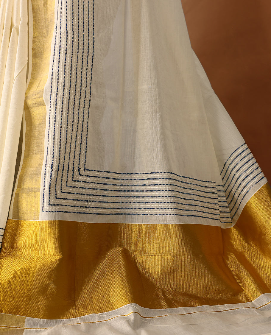 Elegant off white colour cotton Kerala saree featuring Blue colour Thread detailing on body, gold zari traditional kasavu border, Paired with matching blouse offering a classic and graceful look, paired with a matching blouse.