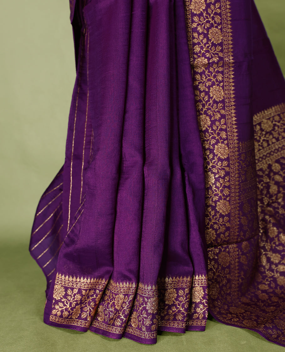 Purple colour Tussar Banaras saree featuring a plain body, rich floral woven zari border and grand pallu, paired with a matching blouse for an elegant and regal traditional look.