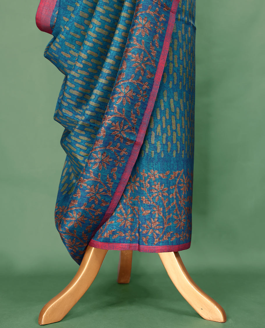 Light Blue Colour Manipuri saree features a brick patterned body in olive hues, beautifully offset by a contrasting magenta border with copper floral-printed, and comes with a matching blouse.