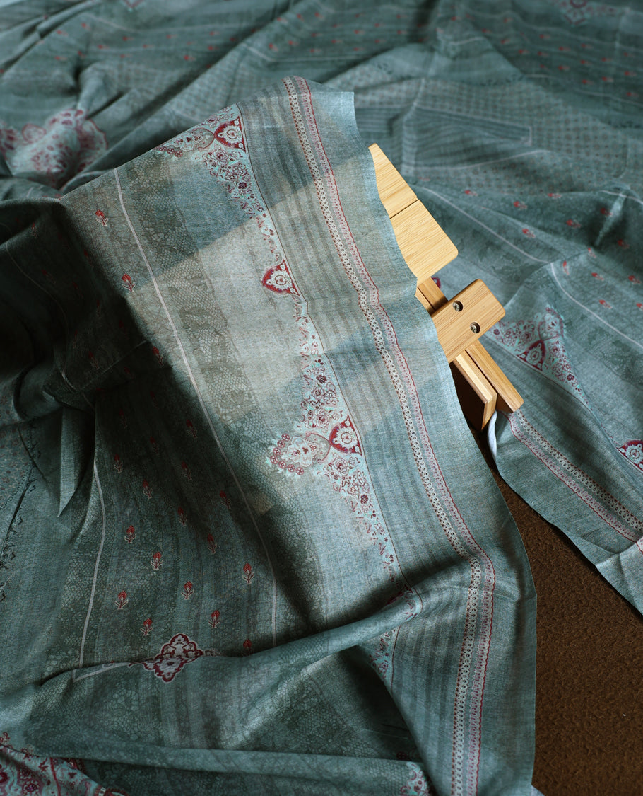 Pastel green colour churidhar material with intricate thread embroidery and sequin highlights, paired with a plain matching bottom and a soft printed dupatta for a subtle yet elegant ethnic ensemble.